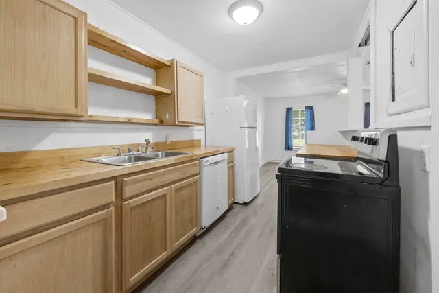 a kitchen with a sink stove and cabinets