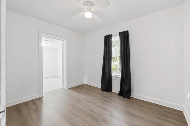 an empty room with wooden floor and closet