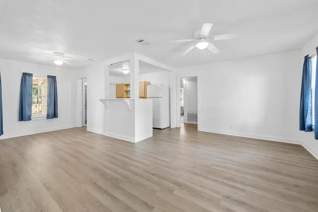 wooden floor in an empty room with a window