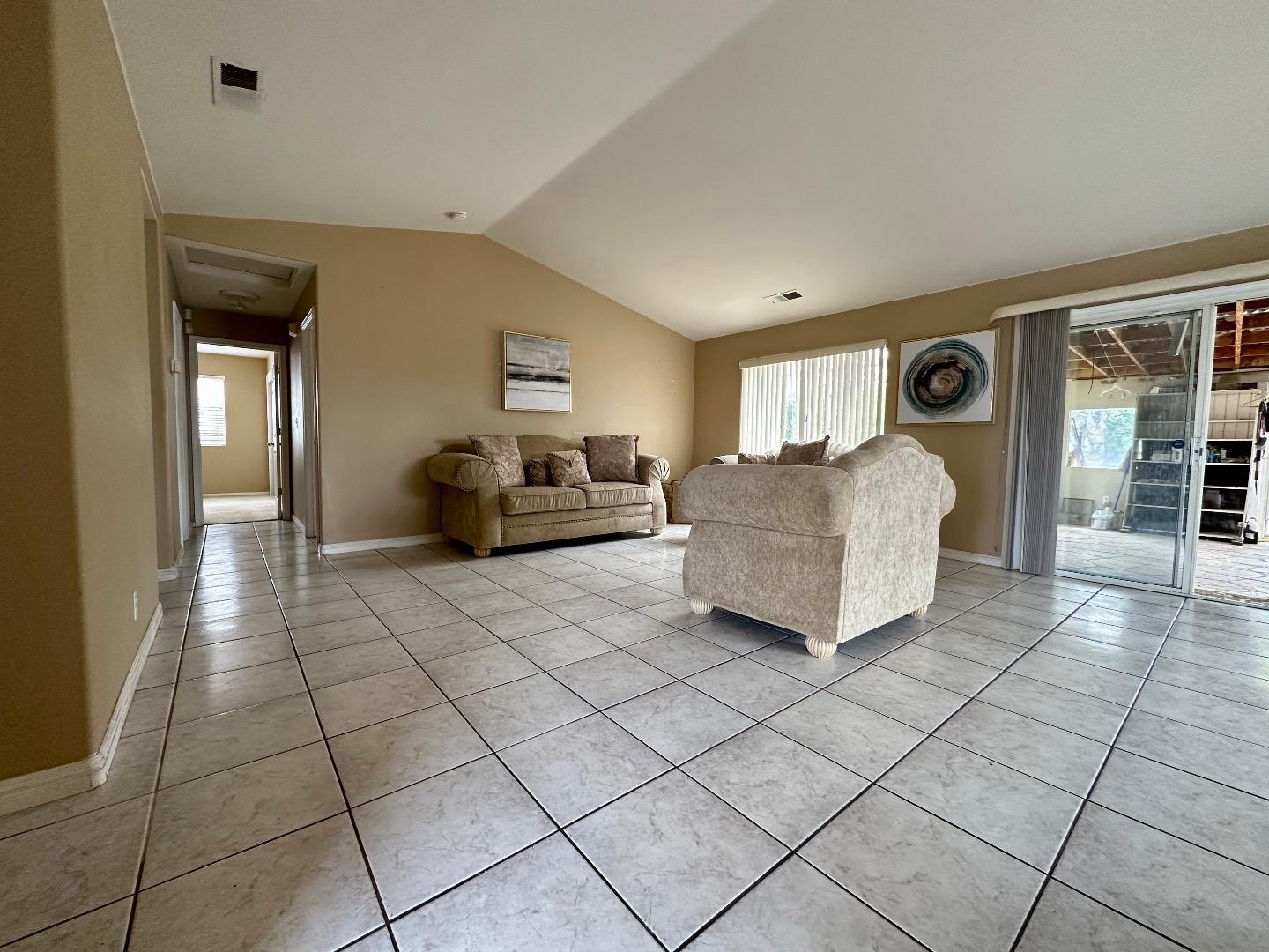 1060 Viewpointe Street Soledad, CA 93960 - Photo 5 of 11 a spacious bedroom with a bed and a lamp