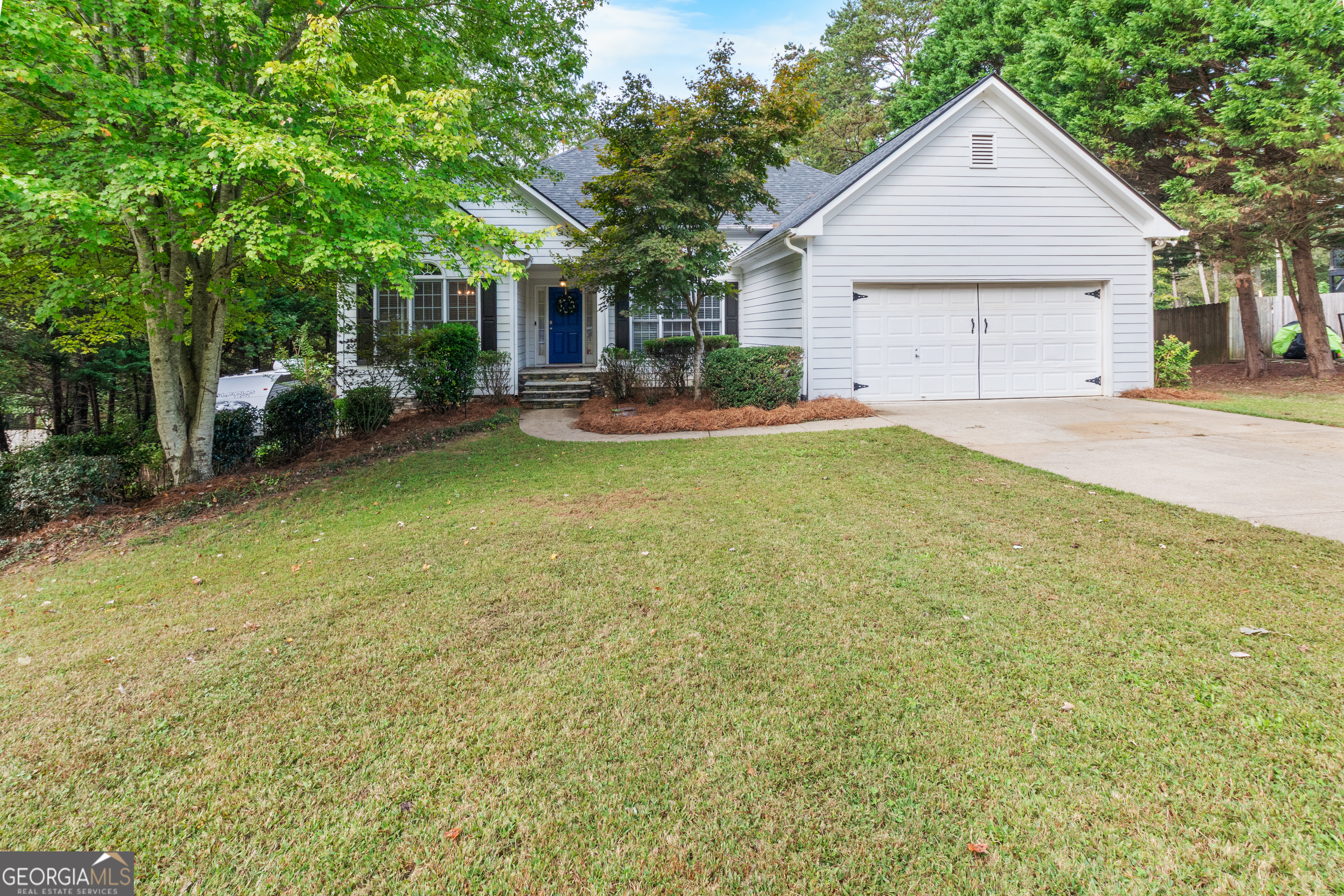 a view of a house with backyard and sitting area