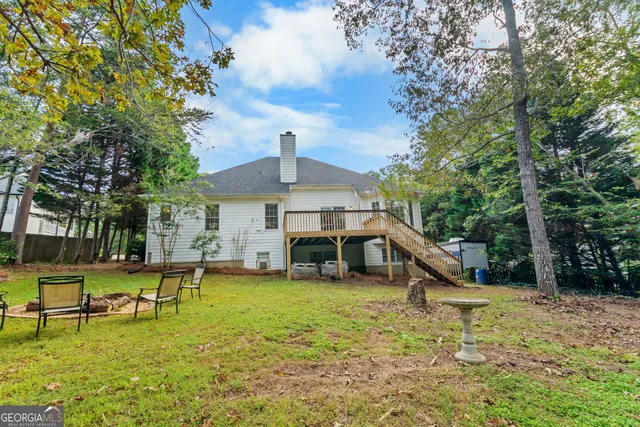 a view of a house with swimming pool and sitting area
