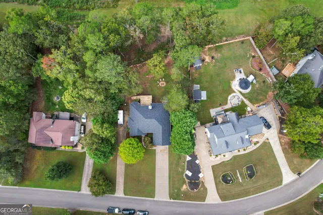 an aerial view of house with yard swimming pool and outdoor seating