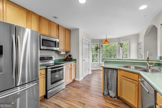 a kitchen with stainless steel appliances a stove sink and refrigerator
