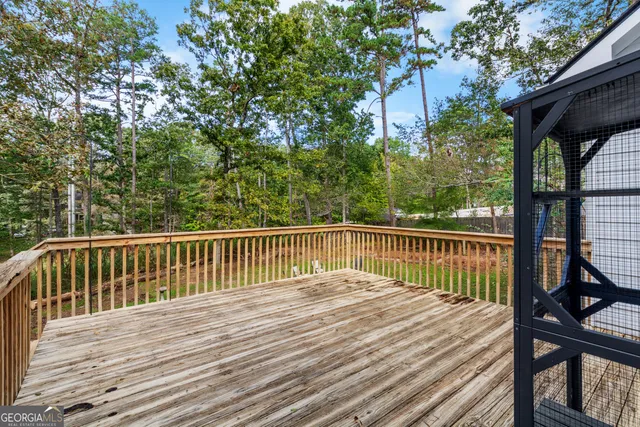 a view of balcony with wooden floor and fence