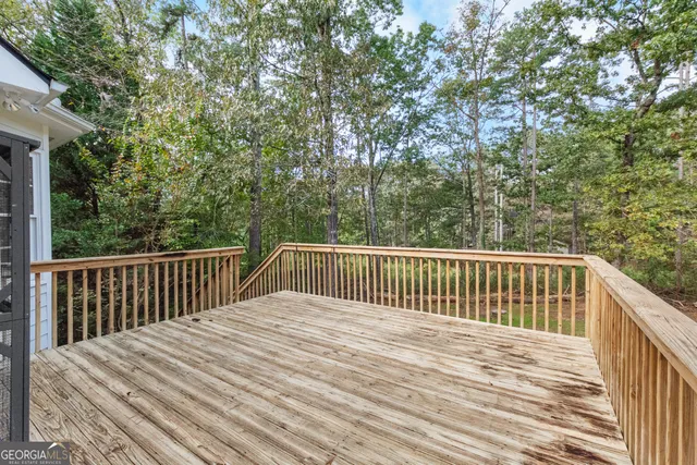 a balcony with wooden floor and fence