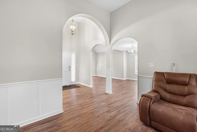 a living room with furniture and a wooden floor