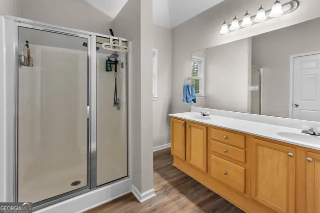 a spacious bathroom with double vanity mirror and shower