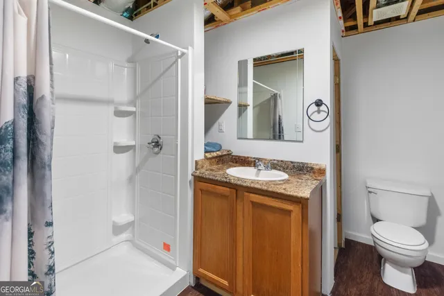 a bathroom with a toilet sink and shower