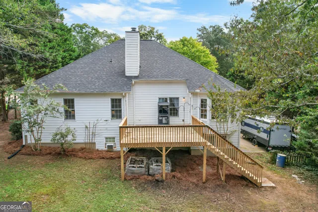 a view of a patio with a table chairs and a barbeque
