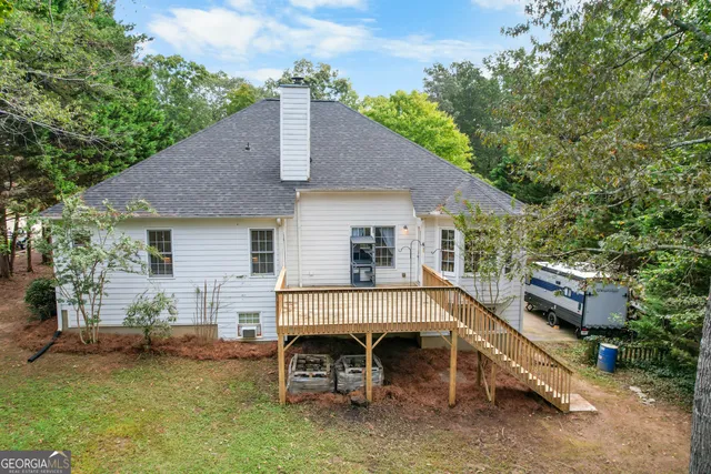 a view of a house with a chairs and a table in a patio