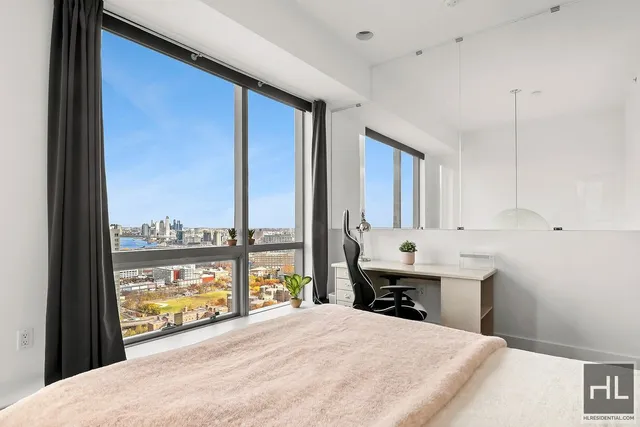 a bedroom with a large bed and a window