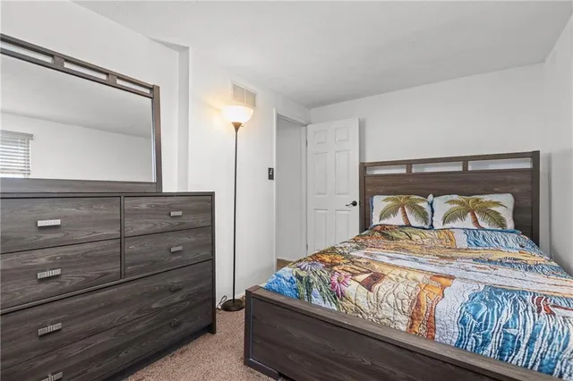 a bedroom with a bed and a mirror