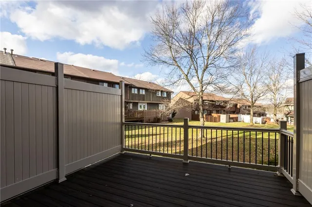 a view of a house with a wooden deck