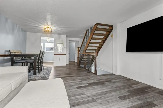 a view of livingroom with furniture wooden floor and windows
