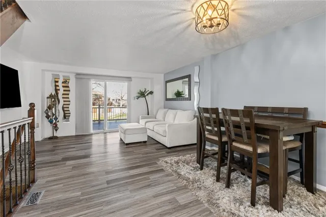 a dining room with furniture a rug and wooden floor