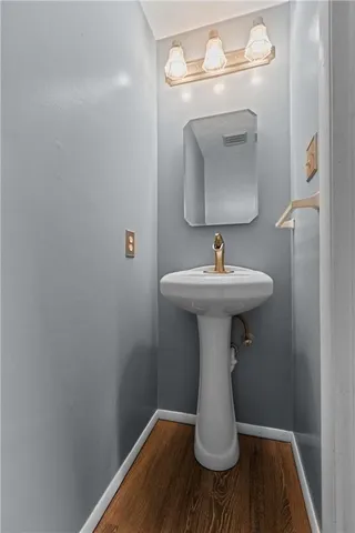 a bathroom with a sink toilet and mirror