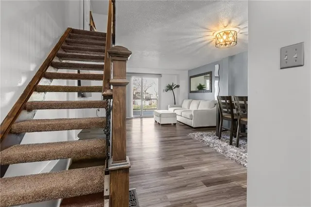 a view of entryway and hall with wooden floor