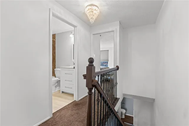 a view of a hallway with a bathroom