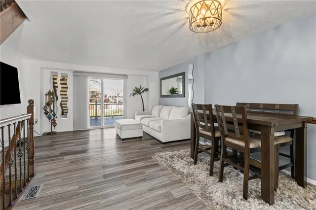 a dining room with furniture a rug and wooden floor