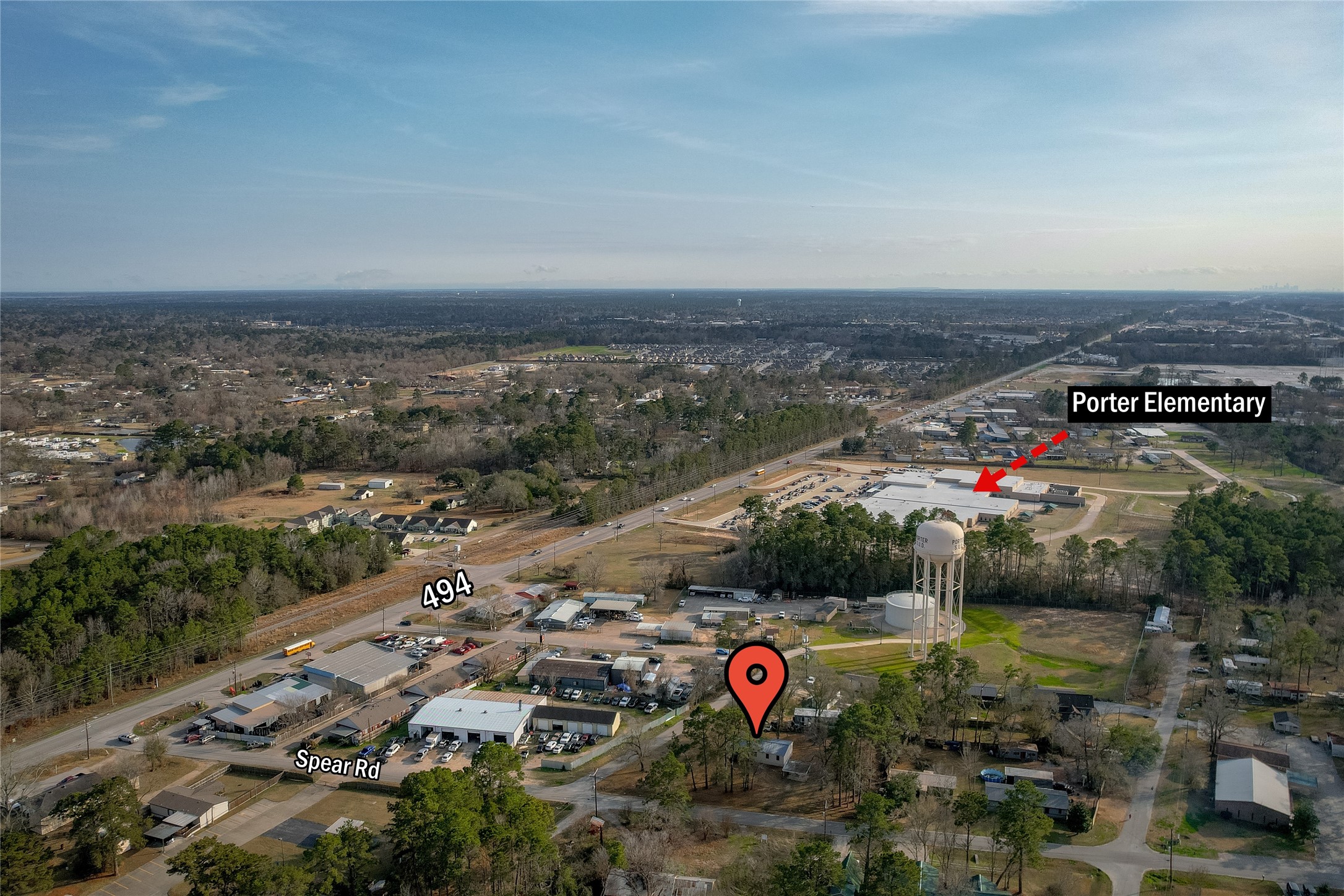 22094 Spear Road Porter, TX 77365 - Photo 41 of 45 This aerial photo shows a spacious residential area surrounded by greenery. Close proximity to Porter Elementary School. Major roads like 494 and Spear Rd are visible, providing easy access to local amenities.