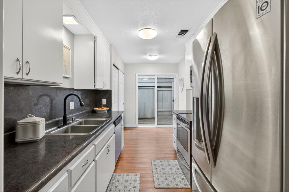 750 Lincoln Road, Unit 62 Yuba City, CA 95991 - Photo 11 of 56 a kitchen with stainless steel appliances granite countertop a refrigerator a stove and a sink