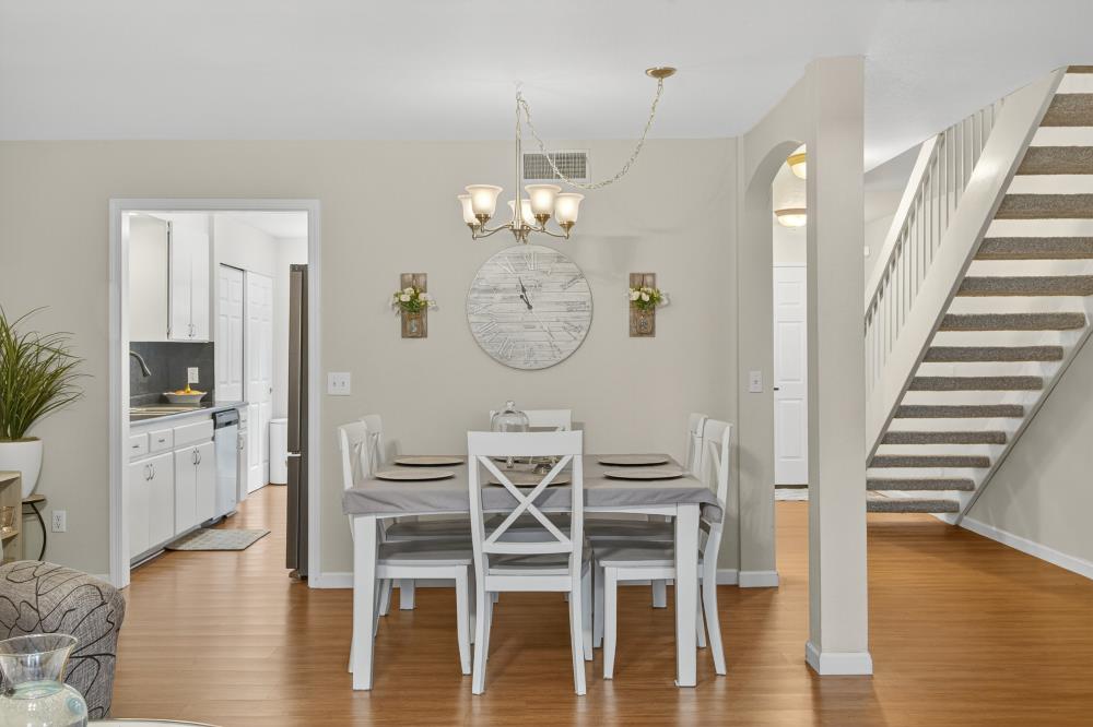 750 Lincoln Road, Unit 62 Yuba City, CA 95991 - Photo 27 of 56 a view of a dining room with furniture wooden floor and a chandelier