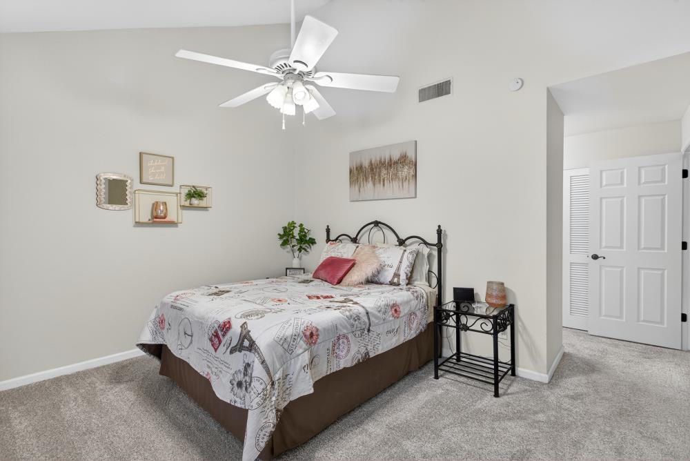 750 Lincoln Road, Unit 62 Yuba City, CA 95991 - Photo 34 of 56 a bedroom with a bed and a chandelier