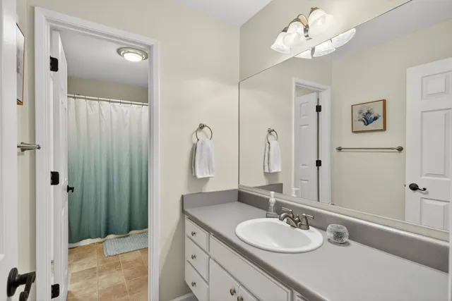 an empty room with chandelier fan