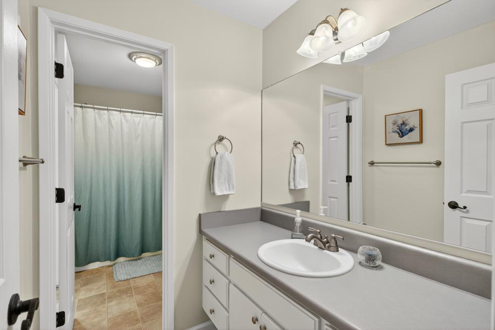 750 Lincoln Road, Unit 62 Yuba City, CA 95991 - Photo 39 of 56 a bathroom with a granite countertop sink a mirror and a shower