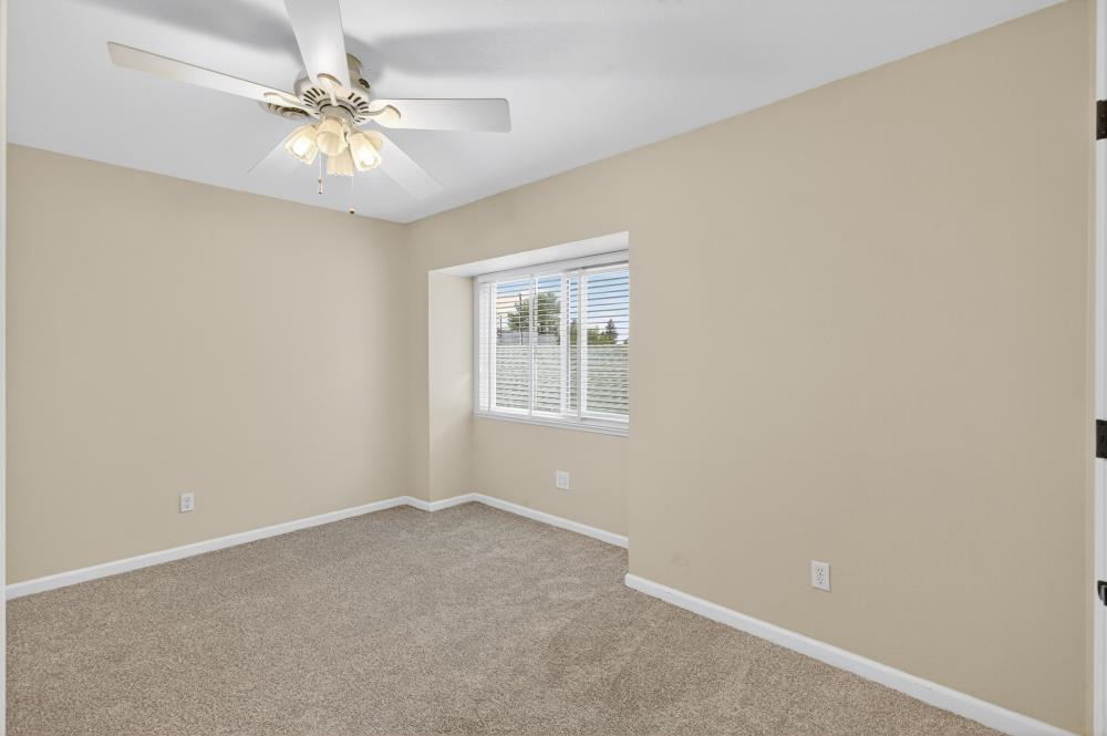 750 Lincoln Road, Unit 62 Yuba City, CA 95991 - Photo 42 of 56 an empty room with a chandelier fan and windows
