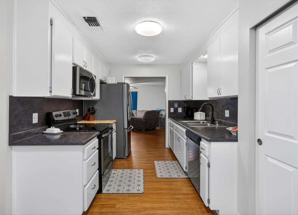 750 Lincoln Road, Unit 62 Yuba City, CA 95991 - Photo 8 of 56 a kitchen with stainless steel appliances granite countertop a stove and a sink