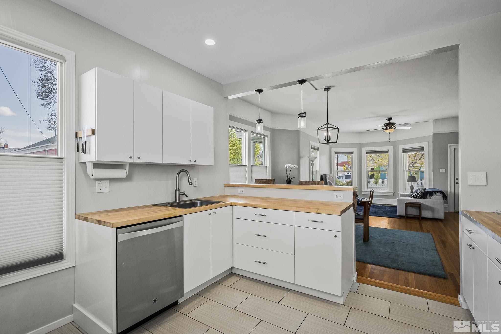 546 Sinclair Street Reno, NV 89501 - Photo 12 of 27 a kitchen that has a lot of cabinets in it and wooden floors