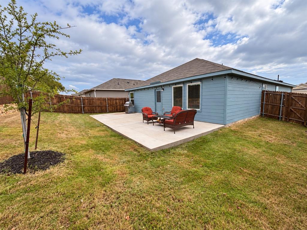 11726 Bone Spg Drive Rhome, TX 76078 - Photo 27 of 29 Spacious fenced backyard with an extended concrete patio offering plenty of room for outdoor seating, grilling, and entertaining.