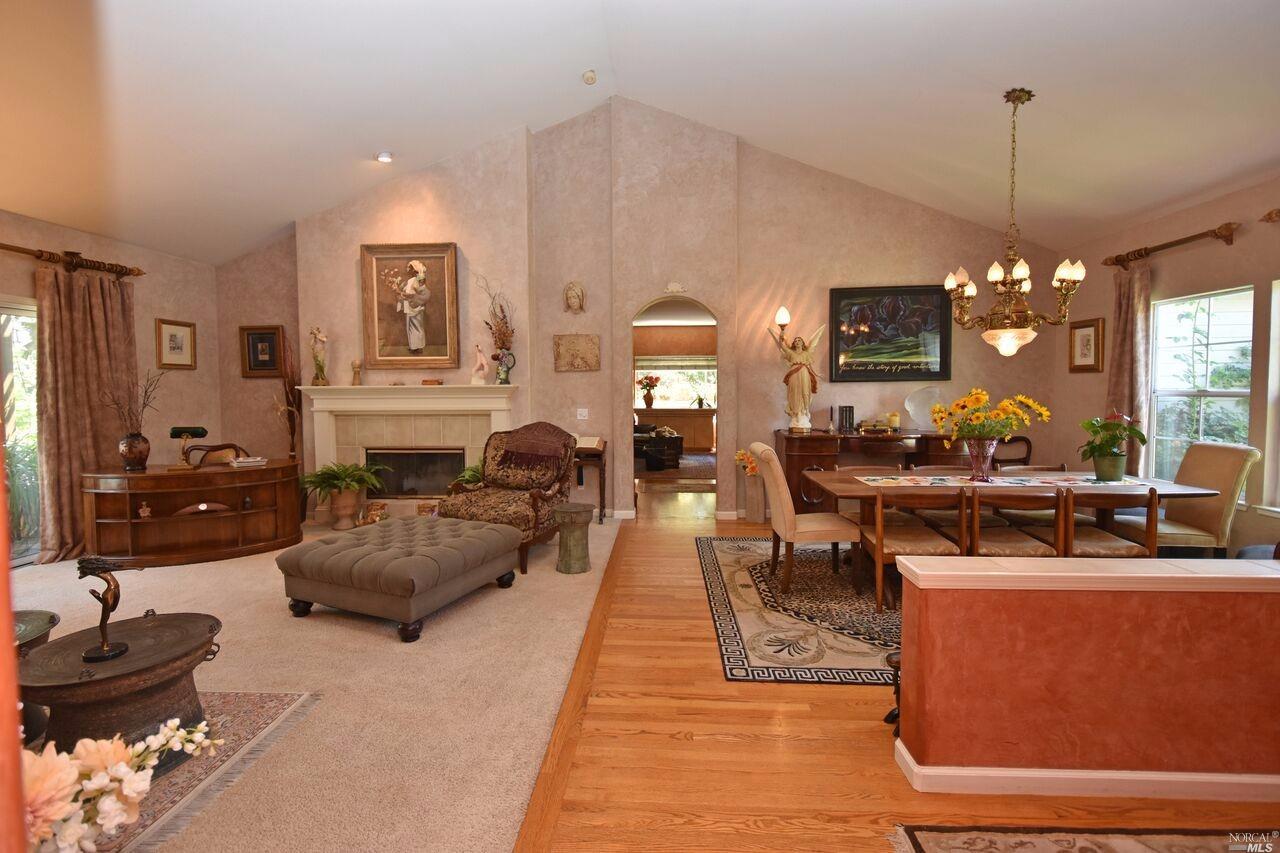 5968 Stone Bridge Road Santa Rosa, CA 95409 - Photo 1 of 1 a living room with furniture a chandelier a rug and a window