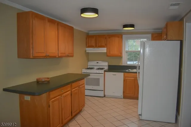a kitchen with stainless steel appliances granite countertop a refrigerator sink and cabinets