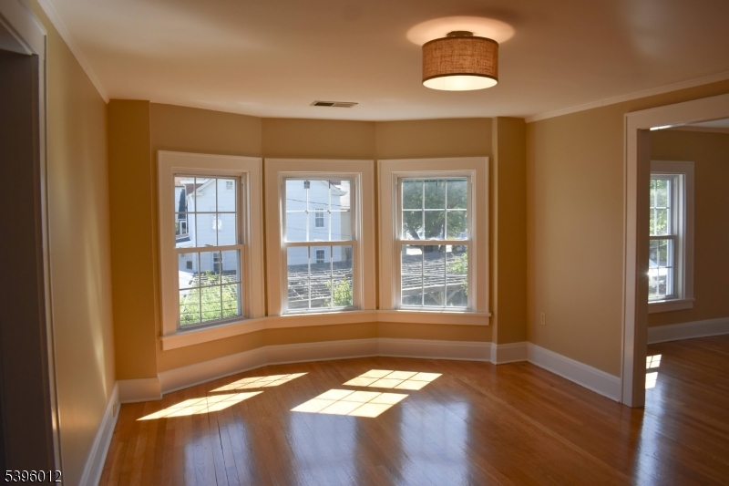 13 West Main Street Mendham, NJ 07945 - Photo 3 of 17 a view of an empty room with wooden floor and a window