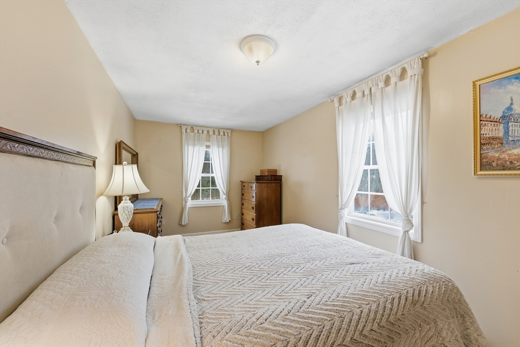 45 Pike Street Athol, MA 01331 - Photo 24 of 38 a bedroom with a bed and a large mirror