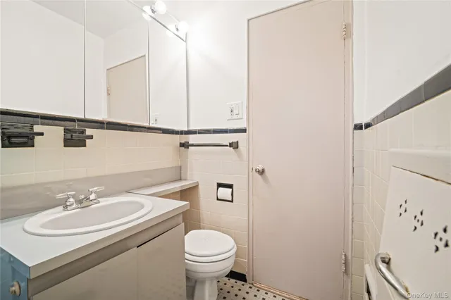 a bathroom with a sink toilet and a mirror