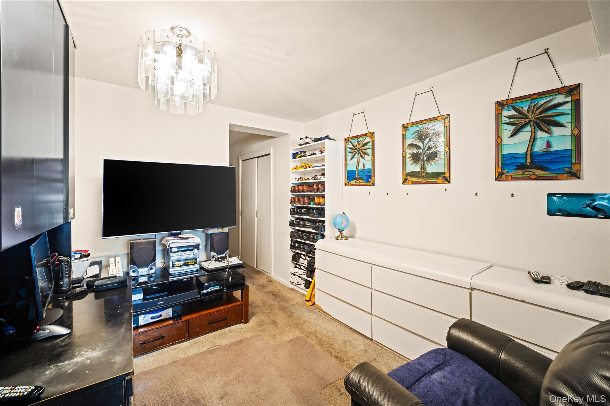 211-02 75th Avenue, Unit 1L Queens, NY 11364 - Photo 3 of 16 a living room with furniture and a flat screen tv