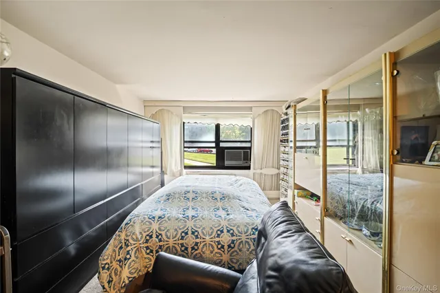 a living room with a large window and a chandelier