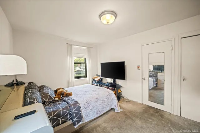 a bedroom with furniture and a flat screen tv