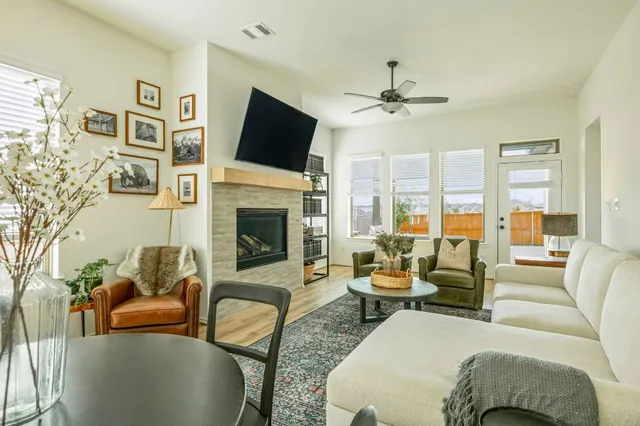 a living room with furniture fireplace and flat screen tv