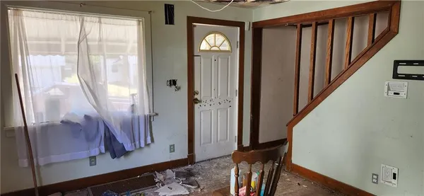 a view of an entryway with wooden floor