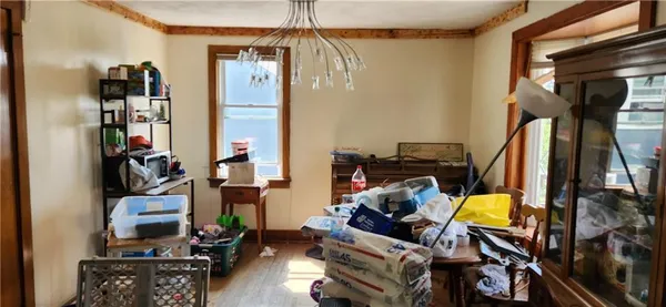 a kitchen with lots of clutter and cabinets