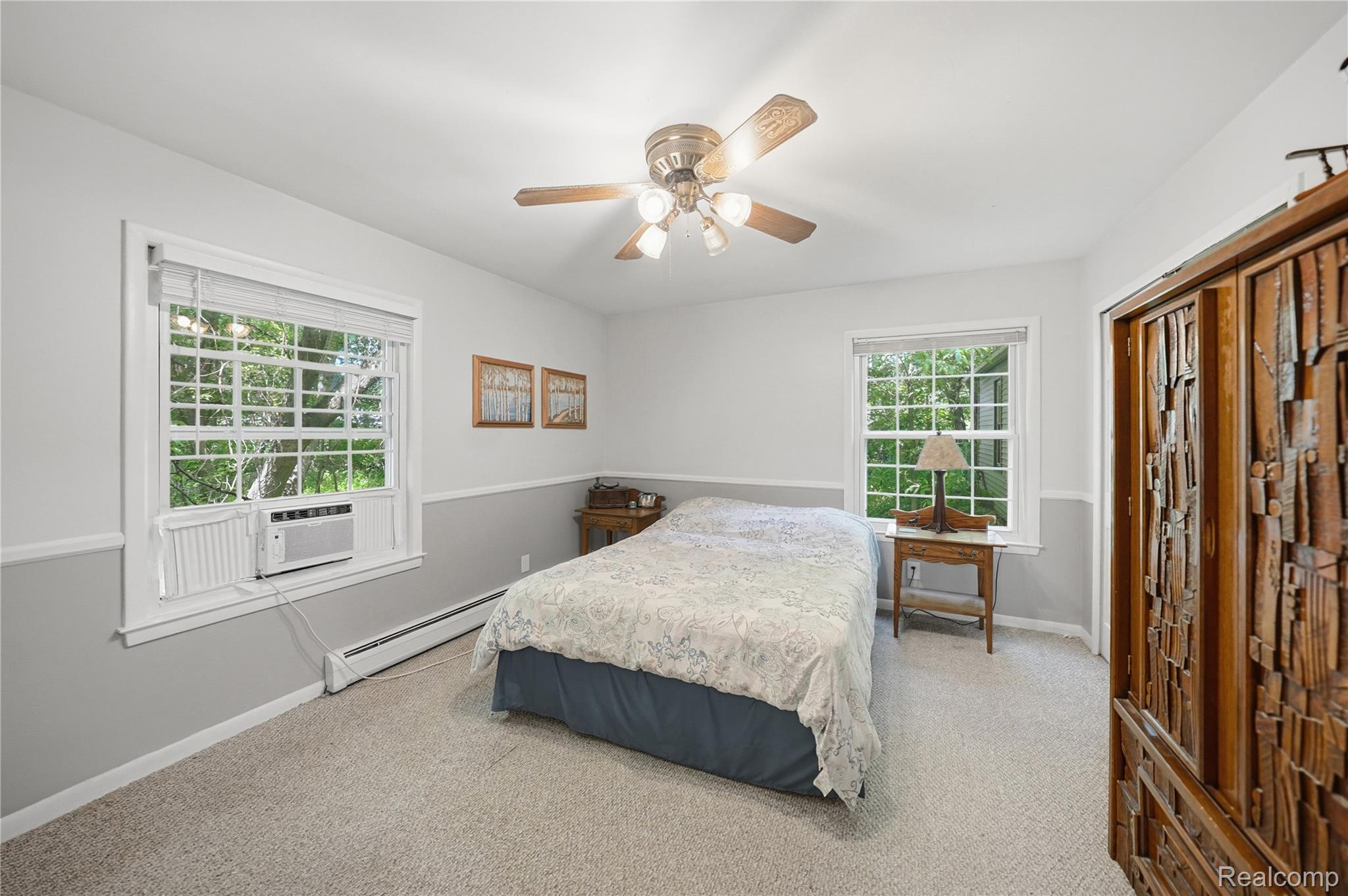 6790 Weyer Road Imlay City, MI 48444 - Photo 17 of 34 Carpeted room featuring a ceiling fan with light fixture, two paneled windows, a window-mounted air conditioning unit, and baseboard heating