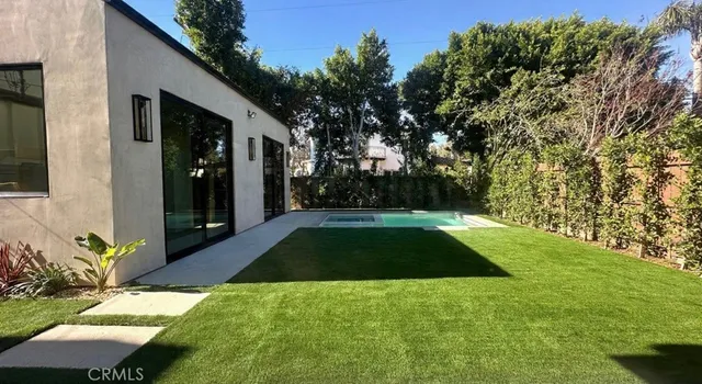a view of backyard with patio