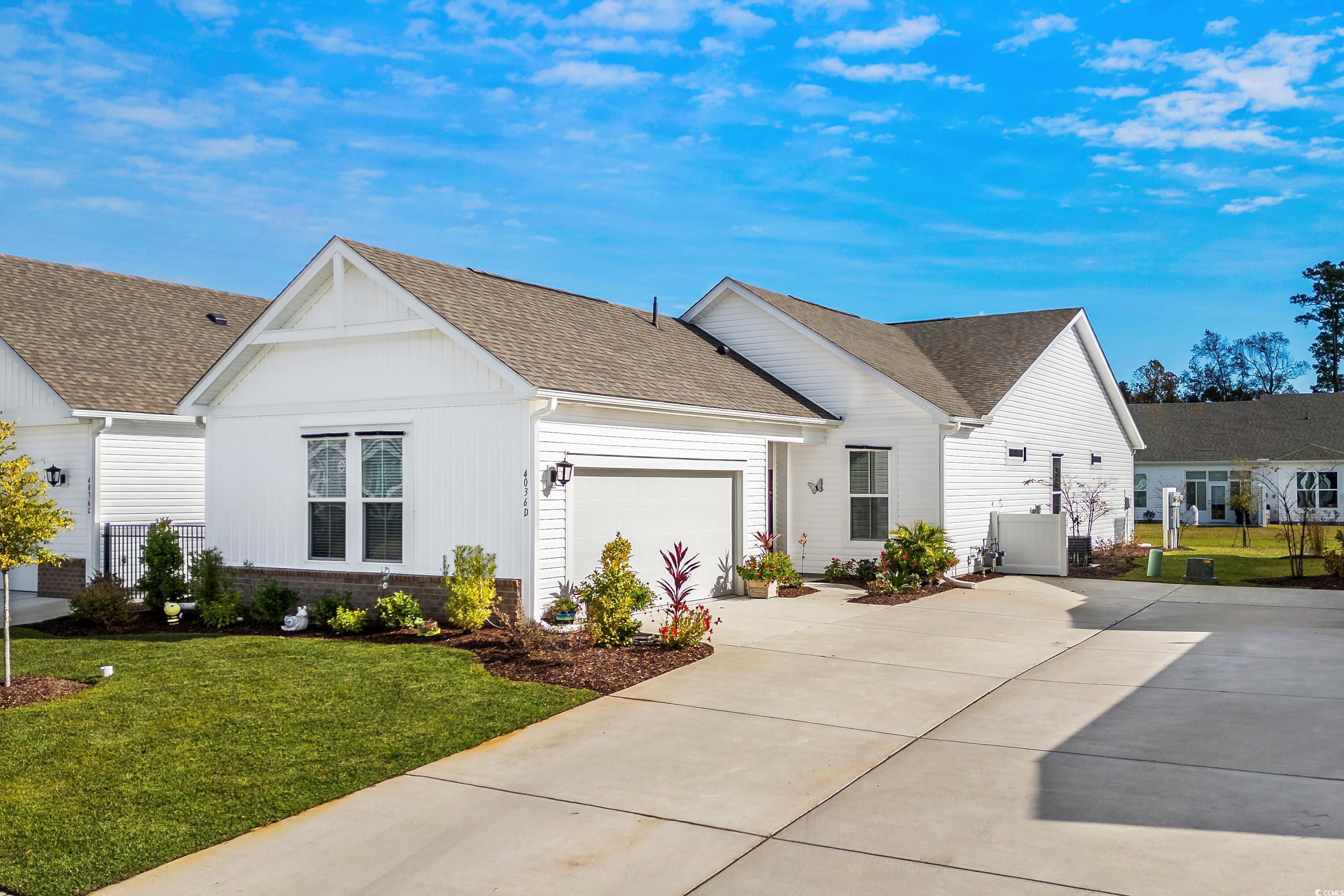 4036 D Taranto Loop, Unit 5404D Myrtle Beach, SC 29579 - Photo 1 of 39 View of front of house with a garage and a front y