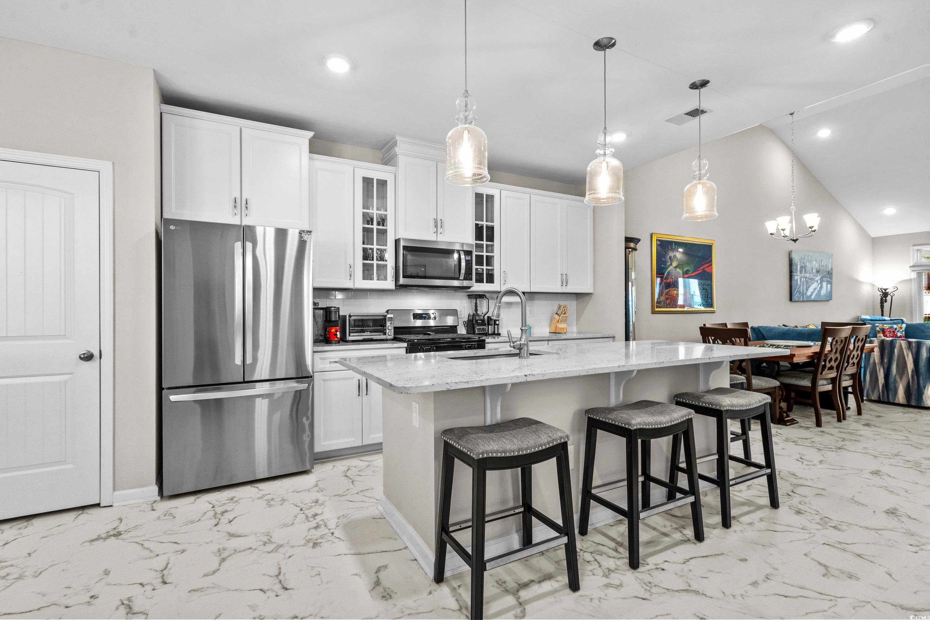 4036 D Taranto Loop, Unit 5404D Myrtle Beach, SC 29579 - Photo 13 of 39 Kitchen featuring a center island with sink, penda