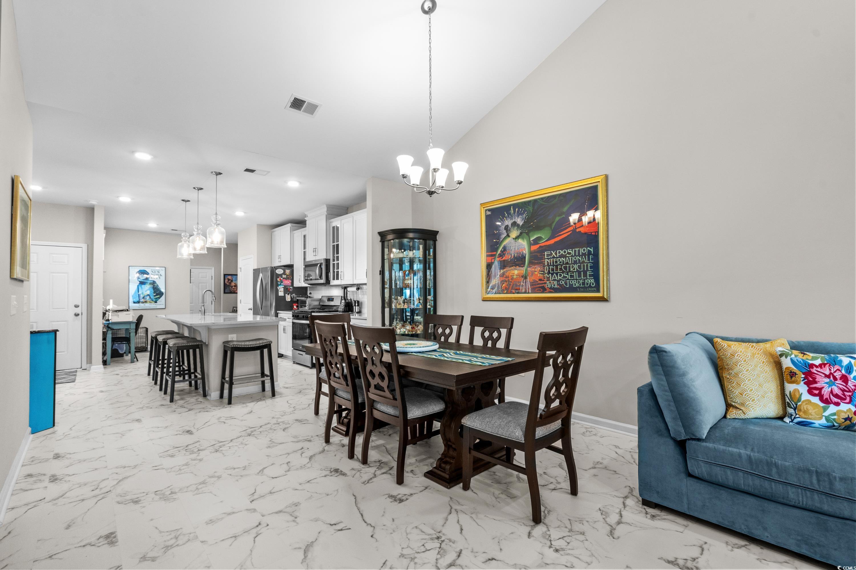 4036 D Taranto Loop, Unit 5404D Myrtle Beach, SC 29579 - Photo 10 of 39 Dining space featuring a notable chandelier, lofte